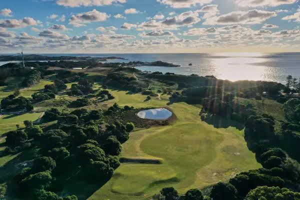 Aerial view of the course greens and the ocean beyond