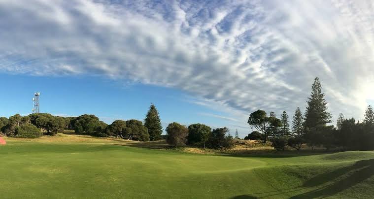 A broad fairway under a big sky